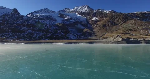 Skating on the frozen lake - Aerial view drone Stock Footage