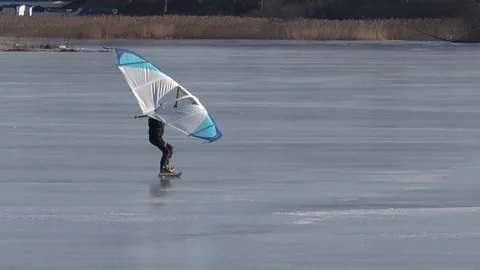 Skating on the ice in winter with a Kitewing Stock Footage 72670314
