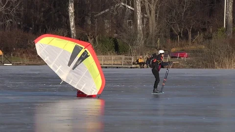 Skating on the ice in winter with a Kitewing Stock Footage 72670512