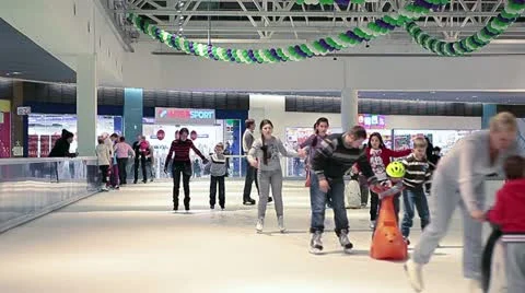 Skating people on rink insideob building Stock Footage