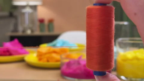 A skein of colored thread spinning in the hand in close-up against the backgroun Stock Footage 306209368