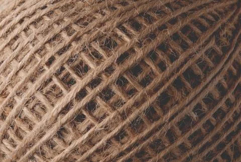 Skein of jute thread texture. micro shot of a coil of jute twine Фото