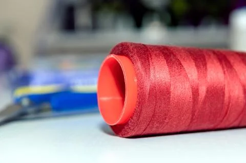 Skein of red thread on a tailor table. Red wool and knitting. Knitting hobb.. Stock Photos