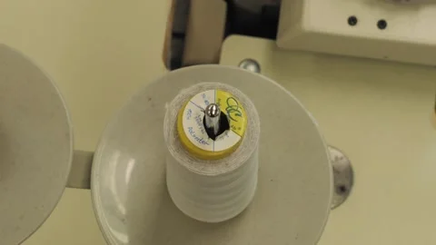 A skein of thread on a spool of an industrial sewing machine. Stock Footage 143012568