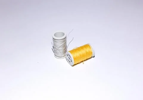 Skein of yellow threads on a white background close-up Stock Photos