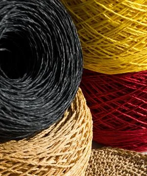 Skeins of multi-colored raffia are ready for knitting. Eco material for han.. Stock Photos