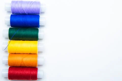 Skeins with threads are lined up in a row according to the color of the rainbow Stock Photos