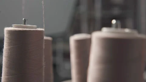 Skeins of threads at the textile industry with knitting machines at the factory Stock Footage 231015236
