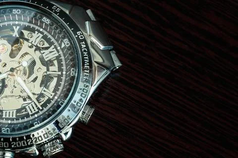 Skeleton clock, mechanical on a background of dark wood tiles. Stock Photos