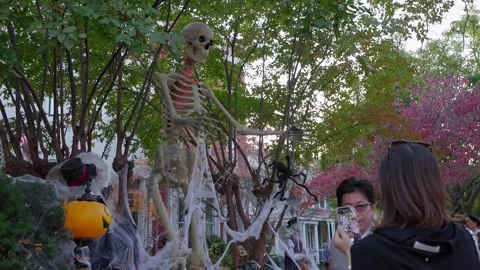 Skeleton decorations in a front garden on Capitol Hill at Halloween Stock Footage 345299593