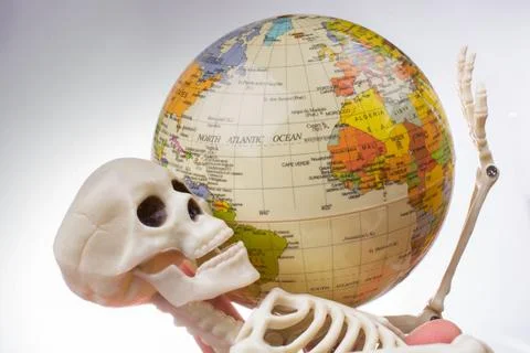 Skeleton with a globe in hands Stock Photos