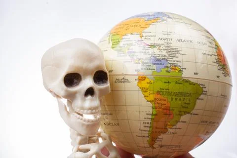 Skeleton with a globe in hands Stock Photos