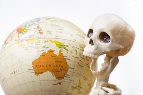 Skeleton with a globe in hands Stock Photos