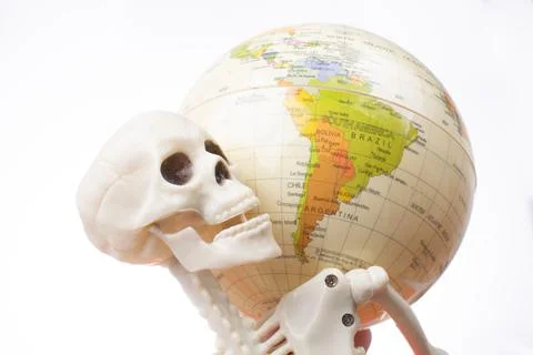 Skeleton with a globe in hands Stock Photos