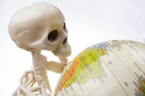 Skeleton with a globe in hands Stock Photos