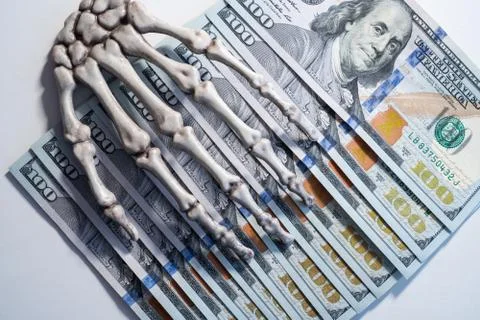 Skeleton hand lies on dollars Illustrazione stock