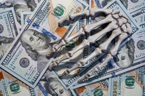 Skeleton hand lying on the dollars. Illustrazione stock