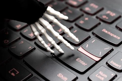 Skeleton hand ready to work on computer, laptop gaming keyboard Stock Photos