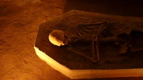 Skeleton laid down in a tomb inside a cave Stock Footage 40013615