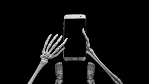 Skeleton Looking Down Using Cell Phone Stock Photos