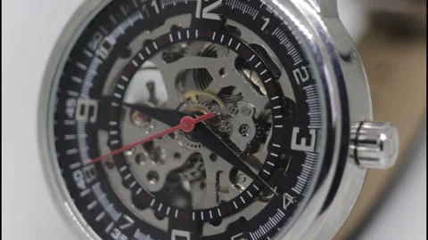 Skeleton Mechanical Wristwatch with Visible Gears and Red Second Hand Stock Footage 325853746