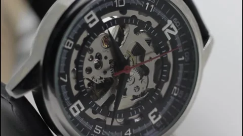 Skeleton Mechanical Wristwatch with Visible Gears and Red Second Hand Stock Footage 325853749