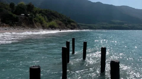 The Skeleton of the Old Pier and Waves at Sea Coast Line Stock Footage 69032768