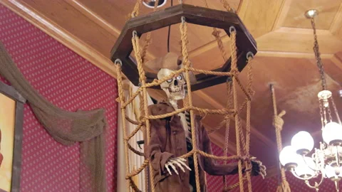 Skeleton of a pirate in his cage inside the lost pirate ship Vídeos de archivo 235392677