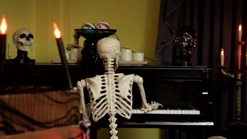 Skeleton Playing Piano Halloween Decorations  with Candles Stock Footage 252680268