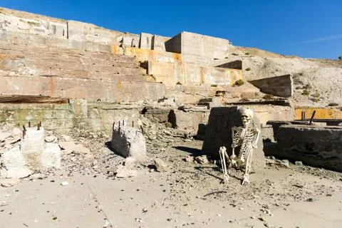 Skeleton posing in mining ruins in the desert on a hot day Stock Photos