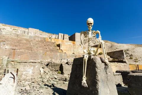 Skeleton posing in mining ruins in the desert on a hot day Stock Photos