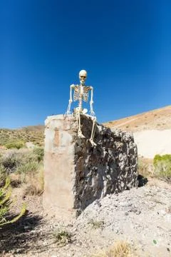 Skeleton posing in mining ruins in the desert on a hot day Stock Photos