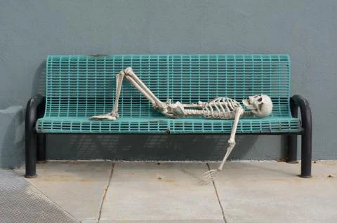 Skeleton reclining on bench Stock Photos