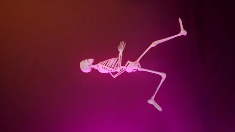 Skeleton runing in loop gradient orange animation. Hhalloween background for Stock Footage 248280872