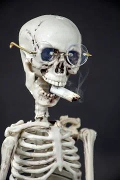 Skeleton smoking a cigarette Stock Photos