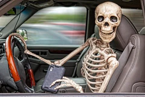 Skeleton texting and driving Stock Photos
