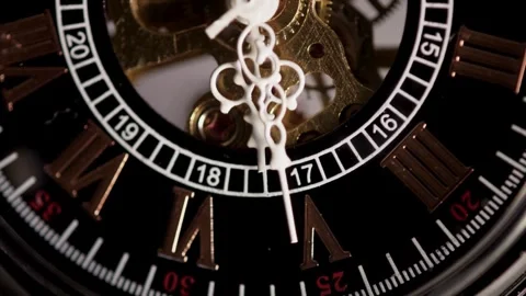 Skeleton watch face with white hands ticking over gears Stock Footage 329595633
