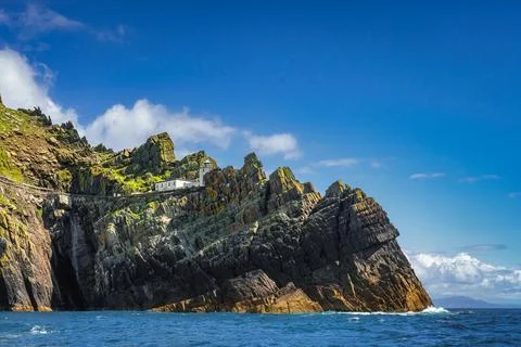 Skellig Lighthouse located on the edge of the cliff on Skellig Michael island Stock Photos