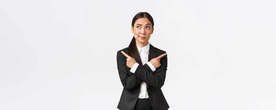 Skeptical and doubtful asian businesswoman hesitating making decision, smirk Stock Photos