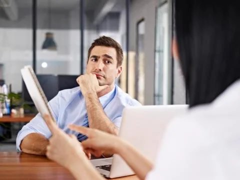 Skeptical interviewer looking at interviewee Stock Photos