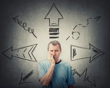 Skeptical thoughtful looking middle aged man, keeps hand under chin, puzzled  Stockfoto's