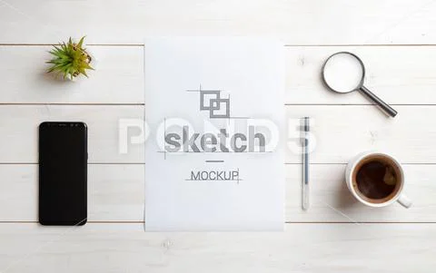 Sketch mockup on blank paper. Top view scene of work desk. Smart phone beside. M PSD Template