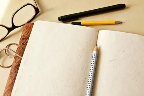 Sketchbook note pad with empty paper page and pencil Stock Photos