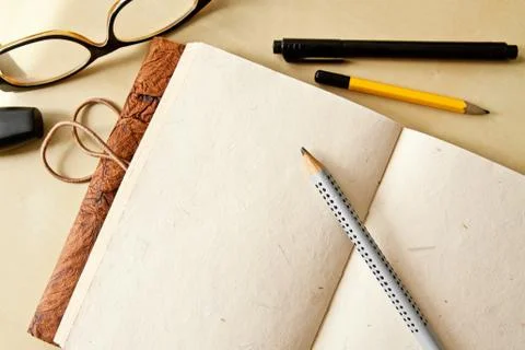 Sketchbook note pad with empty paper page and pencil Stock Photos