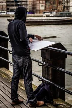A sketcher on a pier Stock Photos