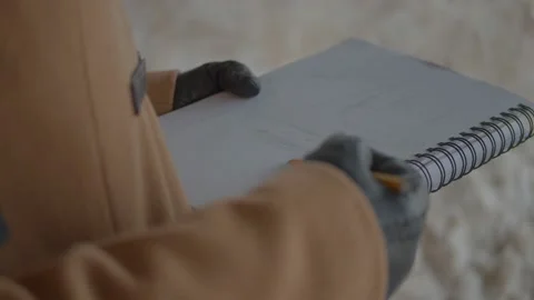 Sketching, Scribbling on a Notebook Outside Stock Footage 194385206