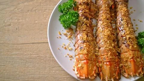 Skewered meat with vegetables served on a white plate Stock Photos