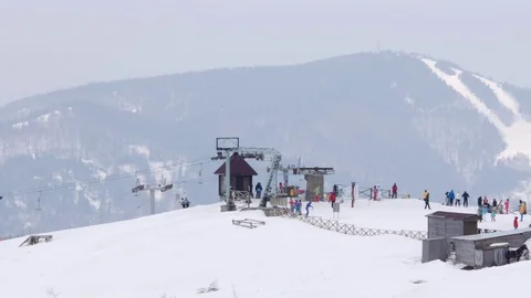 Ski base on the top of the mountain. Two types of ski lifts. Stock Footage 72900897