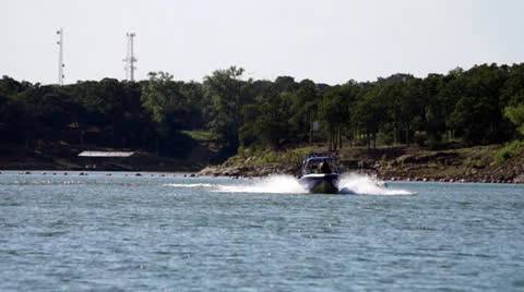 Ski boat pulling skier Stock Footage 23418048