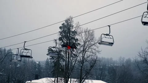 Ski complex, ski lift at a ski resort, two guys riding a ski lift Stock Footage 230878089